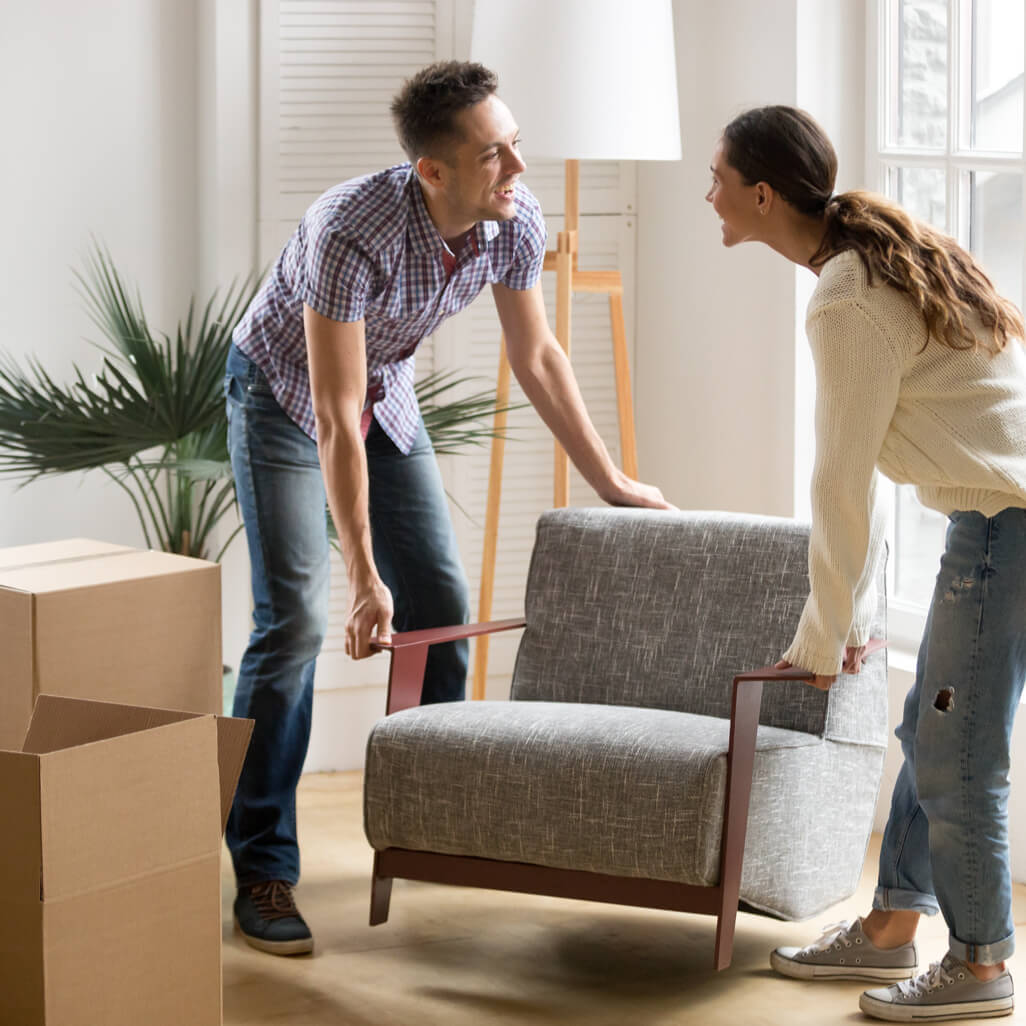 man and woman moving furniture | Roberts Carpet & Fine Floors