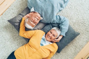 Happy couple lying on carpet | Roberts Carpet